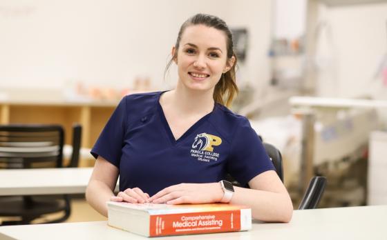 female MA student with book