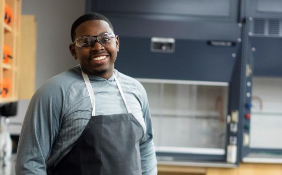 male science student in lap apron